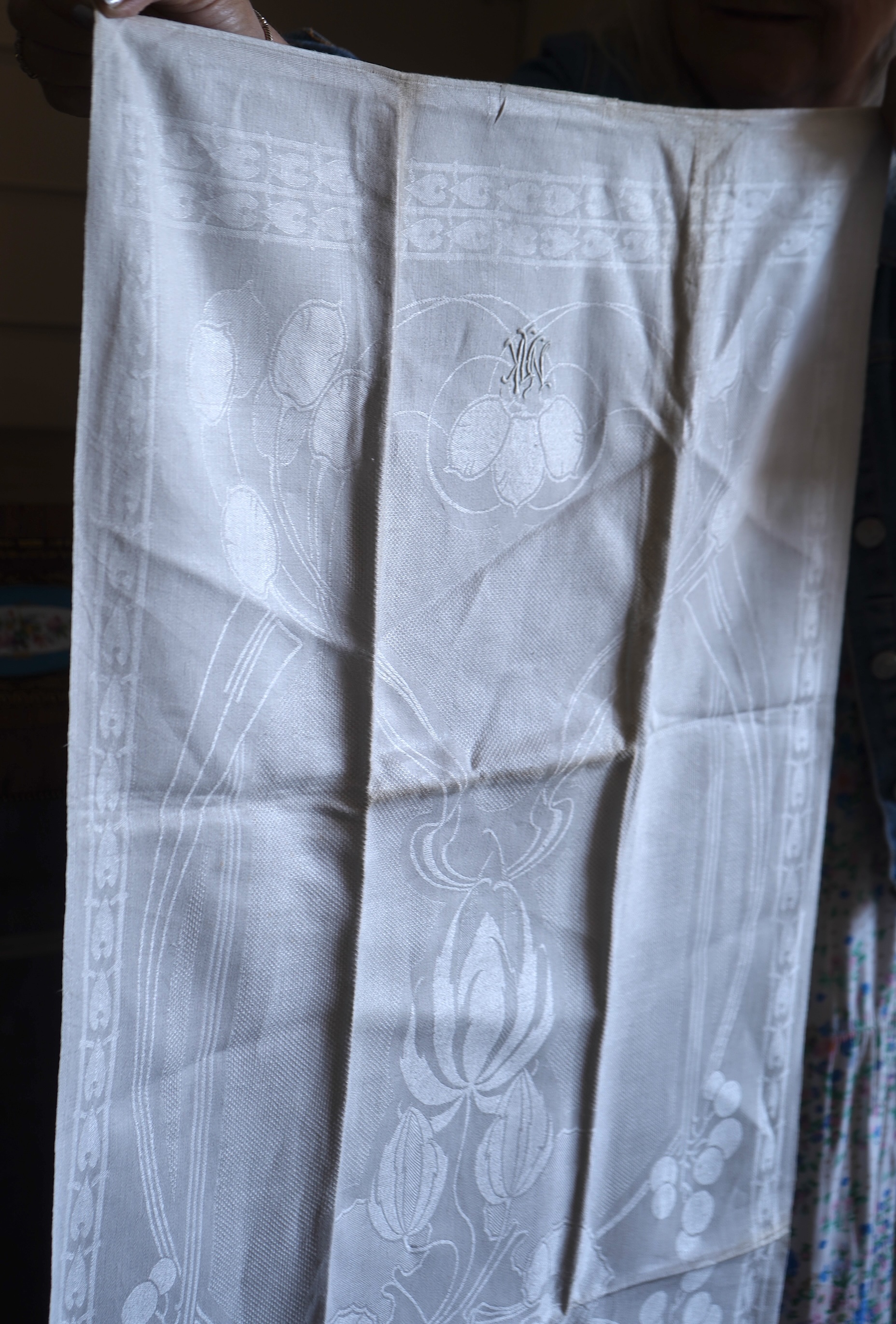 A set of four large Art Nouveau, unused white damask woven hand towels. The pattern having strong Archibald Knox and Walter Crane design elements; with trailing Honesty seeds and Tulip flower heads, these motifs much use